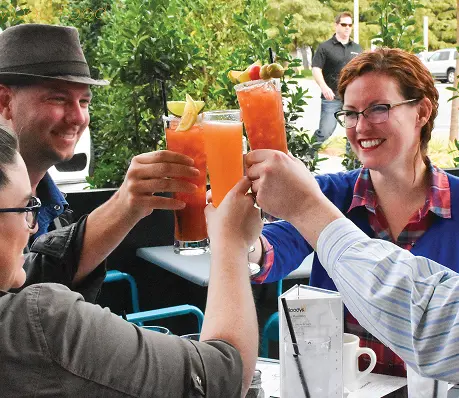 Group clinking Bloody Mary glasses and smiling Group clinking Bloody Mary glasses and smiling