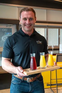 Hatch server holding Mimosa tray Hatch server holding Mimosa tray