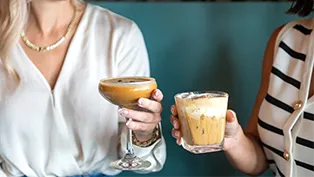 Two hands holding Hatch espresso cocktails Two hands holding Hatch espresso cocktails